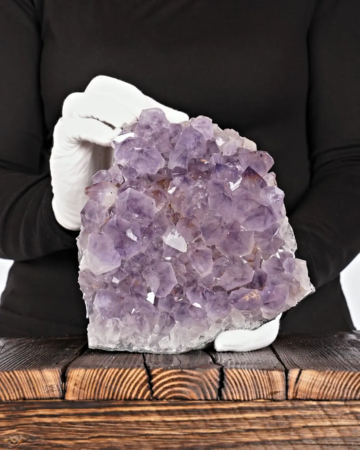 Amethyst Druse Nr. 200 in weiss behandschuhten Händen